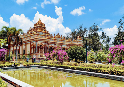 An ornamental pond in front of the ornate Vinh Trang Ancient Pagoda, a popular tourist attraction on the Mekong River tour.